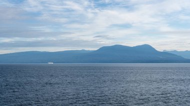 GEORJİA, CANADA 'NIN STRAIT - 29 Haziran 2024: Ufuktaki Britanya Kolumbiyası Kanada ufuktaki Gürcistan mavi gökyüzü su manzarası dağları üzerindeki bulutlar