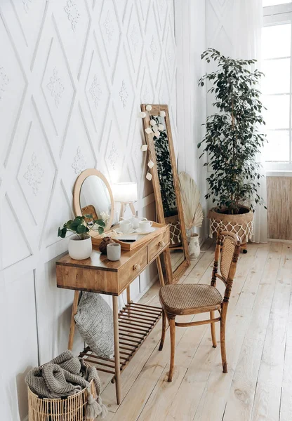 stock image Wooden console table with vintage chair. Plant in a pot indoors. Scandinavian style handmade wooden furniture. Boho style interior. Nobody.