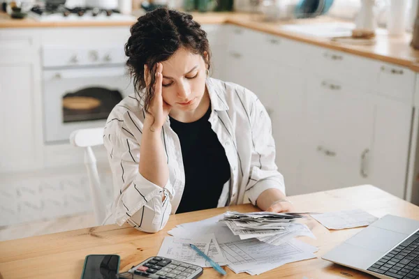 Stressed caucasian woman trying to deal with financial documents, having problem to find money to pay utility bills or loans. The concept of debt, bankrupt. Accounting companies advertisement mockup.
