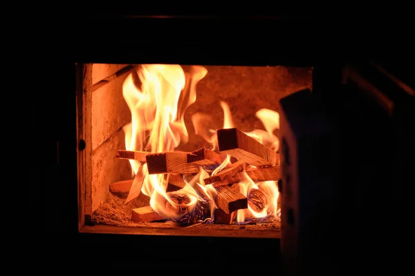Burning logs and ashes inside a wood-burning fireplace