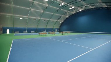 Mavi ve yeşil yüzeyi ve metal kıvrımlı çatı yapısı altında beyaz çizgileri olan boş bir tenis kortu