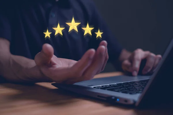 hand of customer or client holding the stars to complete five stars, Service rating, satisfaction concept,giving a five star rating,with copy space.