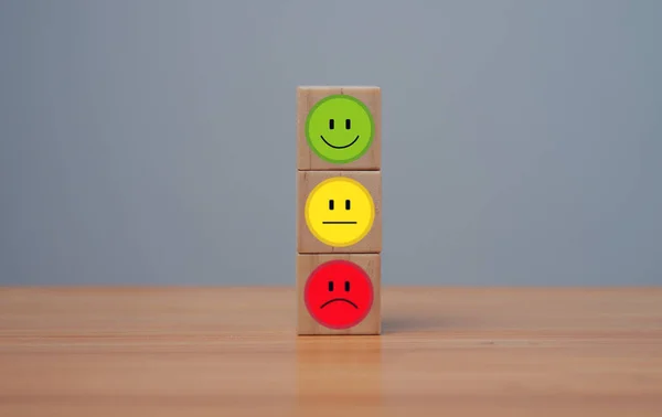 Smile face in bright side and sad face in dark side on wooden block cube for positive mindset selection, Customer experience survey and satisfaction feedback concept.