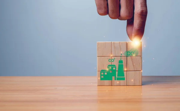 Climate neutral long term strategy. Hand put wooden cubes with decrease carbon emission icon and green icon.Low carbon,carbon neutral concept. Green banner.