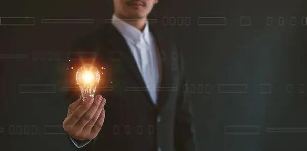 Idea Innovation Inspiration Concept Hand Man Holding Illuminated Light Bulb 免版税图库图片