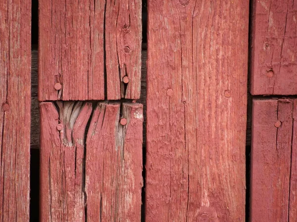 old rustic red wall painted with red mulch paint in daylight. High quality photo