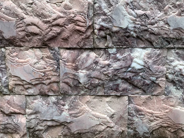 Brick wall texture, closeup of an old exterior surface as a background. Building face wall, convex joint line between dissimilar faded bricks brings character and dimensionality to vintage masonry.