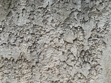 Çizgili Stucco duvar kapağı, hafif grunge arkaplan dokusu. Bej, kum veya açık kahverengi dekoratif alçı yatay olmayan oluklara sahip solucan bir evin ön cephesinde nötr gölgede bitirir..