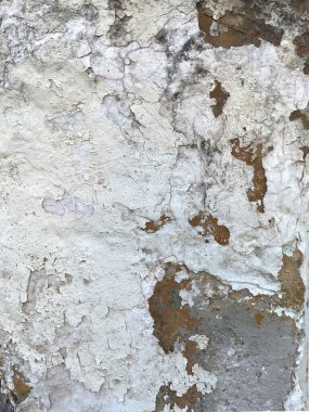 Eski çatlak, pul pul dökülen beyaz boya ve tuğla duvarda alçı tabakalar, grunge arkaplan dokusu olarak yakın plan. Çürümüş ve yıpranmış siyah küf lekeleri olan kaba, kirli bir yüzey..