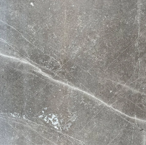 大理石のタイルの質は抽象的な背景として閉じます 天然のホーニングストーンスラブ マットの陶磁器の壁か床の細部 サテン仕上げの灰色の表面とランダムな不規則な白い斑点のパターン — ストック写真