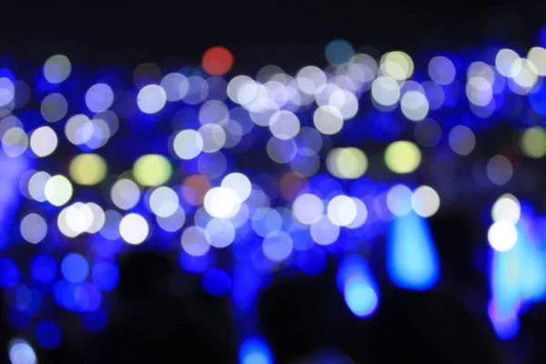 Bokeh effect of light sticks in the concert.  Blue light and blue tone.