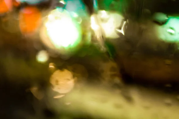 The close-up of raindrops on window at night. For background, for personal blog etc. Blurry effect.