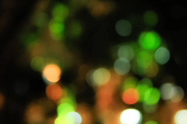 Bokeh effect of street lighting at night. Green and yellow color.