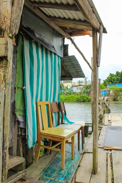Chairs on the wooden dock, beside the river in countryside. Travel scene.