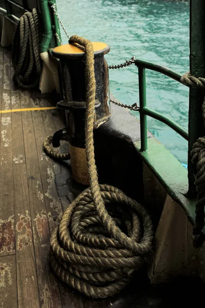 Nautical vessel heavy anchored rope, transportation equipment in selective focus. The rope which is rolled in metal drum, this rope will anchor for stability when the ship is docking at harbour.