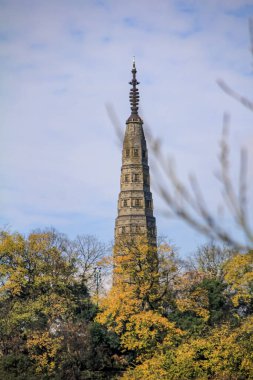 The view of Baochu Pagoda in West Lake with autumn trees in the foreground. Travel and nature scene. On the north side of West Lake on the top of Precious Stone Hill, popular park of Hangzhou, China clipart