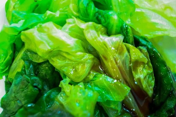 Close-up of lettuce with oyster sauce. Chinese common cuisine. Food concept.