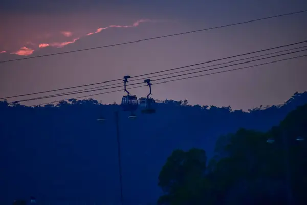 stock image The scene of Cable Car in Hong Kong under the sunset from the view of Tung Chung, Hong Kong. It is one of transportations to the tourist attractions located at Ngong Ping, Lantau Island, in Hong Kong.