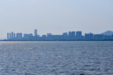 Shenzhen şehri manzarası, Guangdong, Çin Shenzhen Körfezi kıyısından. Yaz gününde şehir. Modern şehir kıyısı şehir merkezi silueti, Çin. Doğa ve manzara.