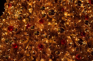 Renkli süslemelerle Noel ağaçlarının yakın çekimi. Şenlik dekorasyonu. Süs eşyalarıyla dolu. Kış mevsimi, kış festivali. Noel kutlaması, Xmas kutlaması. Arkaplan kullanımı için.