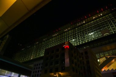 Reflection of Kyoto Tower at night, Kyoto, Japan. Travel concept. Kyoto tower is the tallest building and a major tourist attraction in Kansai region in Japan. clipart