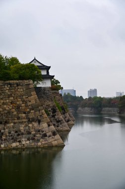 Osaka Şatosu 'nun sonbaharda yağmurlu bir günde çekilmiş bahçe sahnesi, Osaka Japonya. Japonya 'nın Kansai bölgesinde önemli bir turistik ilgi merkezi. Seyahat konsepti. Sonbahar doğa kavramı.