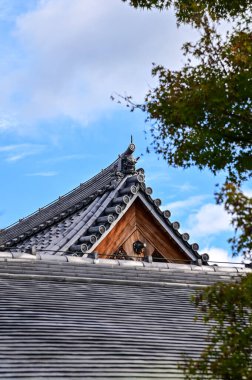 Japonya, Kyoto 'daki Tenryuji Tapınağı' nın çatısında ağaçlarla çevrili. Çatı kiremit deseni. Japonya 'nın Kansai bölgesinde önemli bir turistik ilgi merkezi. Japonya 'nın ünlü tarihi mimarisi. Bina yapısı.