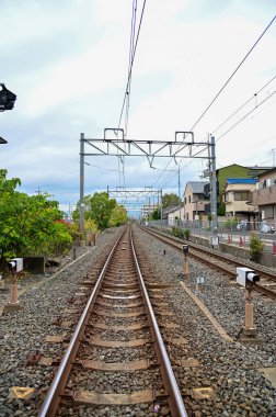 The railway in Fushimi Ward, near Fushimi Inari Taisha (Fushimi Inari Shrine) in Kyoto, Japan. Japan public transportation railway in rural in outdoors. Nature and travel scene. clipart