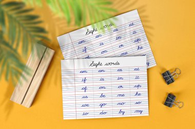 Learning to write cursive sight words, Samples of cursive lettering on lined paper with yellow background. Cursive Handwriting Practice for kindergarten, school homework