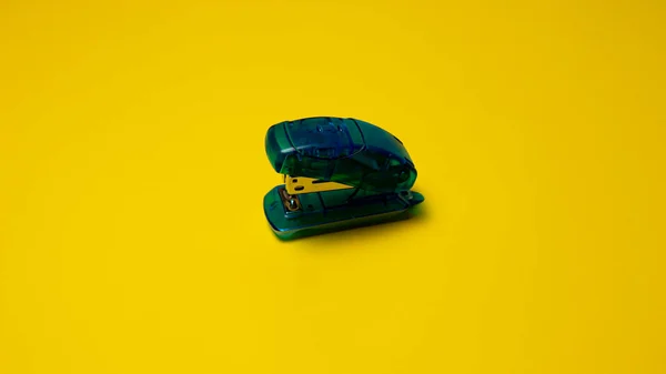 stock image Green stapler isolated on a yellow background. Top view.