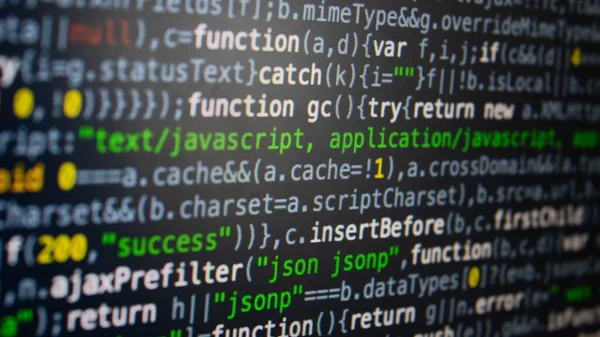 Software development. Programmer coding on the computer monitor. Close-up. Computer program code on a black background. High quality photo