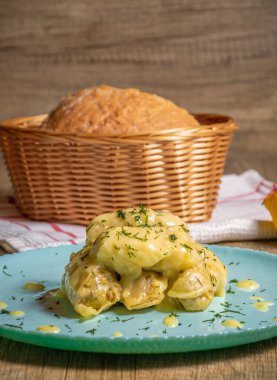 Traditional Greek cabbage rolls (Lahanodolmades) with ground beef, rice and cream sauce on a wooden table