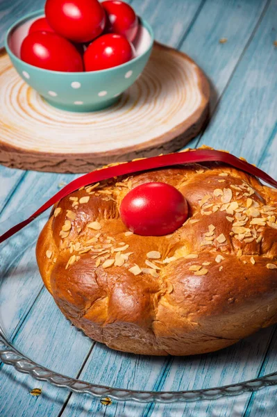 stock image Easter traditional bread, greek tsoureki and red eggs on a table 