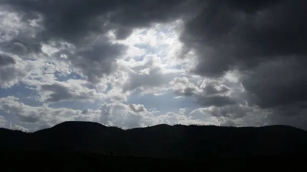 stock image BLUE SKY BETWEEN WHITE CLOUDS WITH APPROACHING STORM CLOUDS.