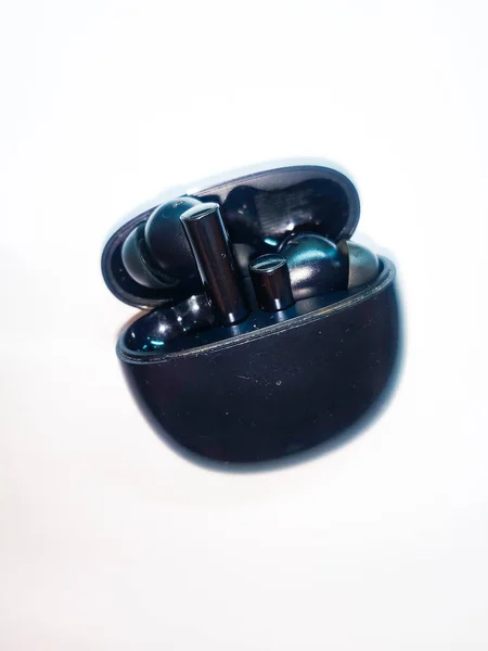 stock image Pair of wireless ear buds with case in white background