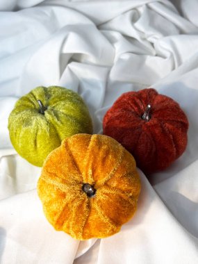 Set of fabric textile pumpkins on a white textile background. Top view. Halloween handmade pumpkins, sewing. clipart