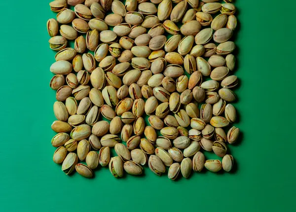 Pistachios on a green background close-up macro