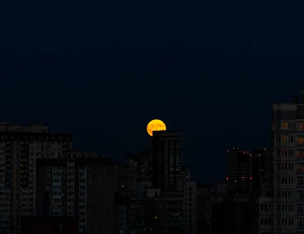 Ay Kiev 'in evlerinin üzerinden yükseliyor.