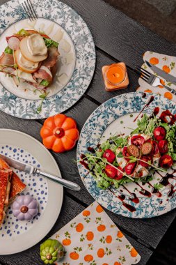 Sandwich with tomato and fish on a blue plate autumn vibe