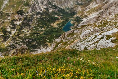 Aerial panorama from Bobotov Kuk mountain peak. Alpine summer landscape with lake and remote green valley in Durmitor National Park. Peaks of Balkans adventurous hiking trail through Montenegro. clipart