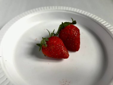 Close up of the strawberry on white plate with white background 