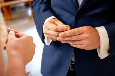 hands, wedding rings and marriage vows the groom holds and puts a wedding ring on the bride's finger