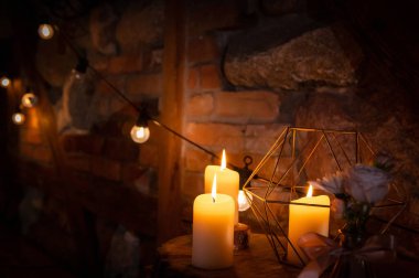 wedding hall interiors and decorations candles and edison bulbs on the background of bricks and stones in bohemian and rustic style