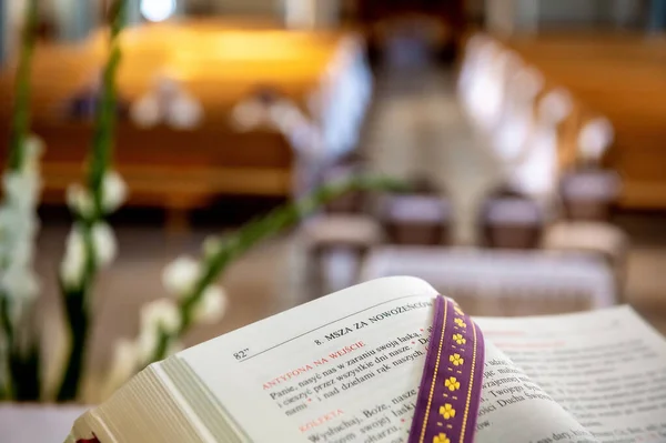 interiors and details in catholic church liturgical book with a church interior blurred in the background