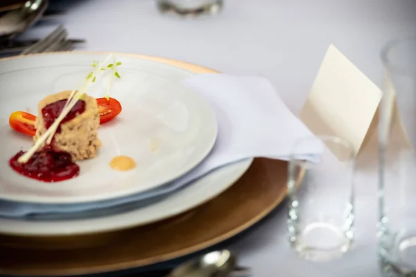 a plate with a dish and a label on the table
