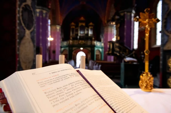 interiors and details in catholic church liturgical book with a church interior blurred in the background