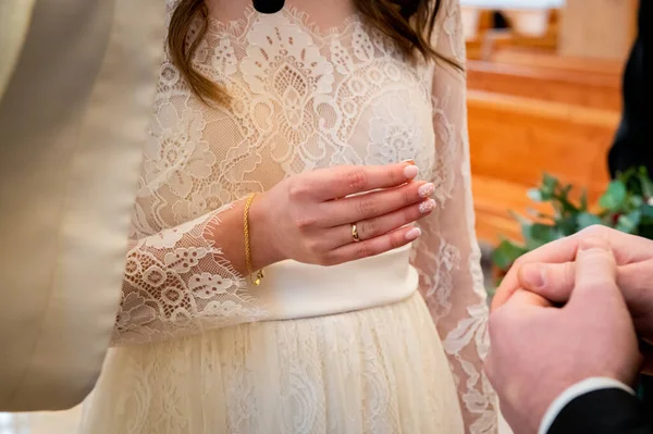 hands, wedding rings and marriage vows the bride holds and puts a wedding ring on the groom's finger