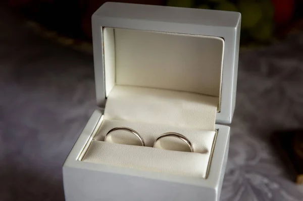 wedding rings and details white box with wedding rings on a table with a white tablecloth