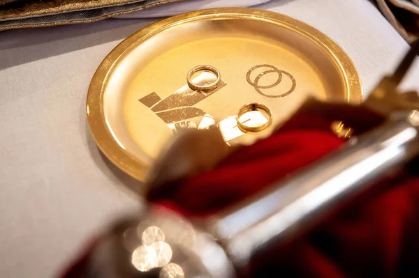interiors and details in catholic church view of the altar, rings and holly water