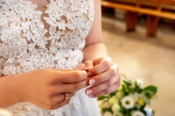 hands, wedding rings and marriage vows the bride holds and puts a wedding ring on the groom's finger